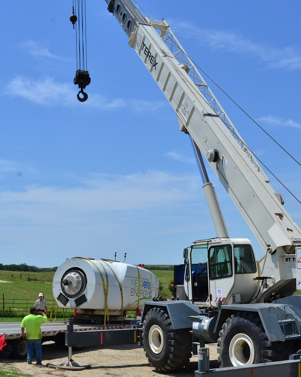 A crane prepares to unload a wind turbine nacelle.